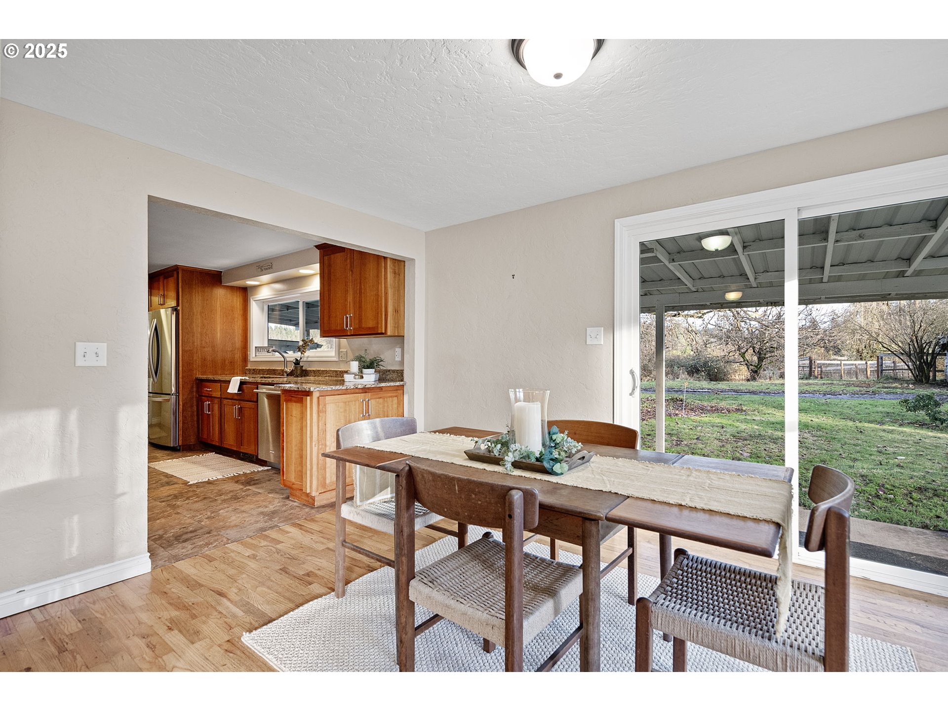 84020 Brown Road Dexter, OR 97431 - Photo 11 of 48 a open kitchen with granite countertop a sink dining table and chairs
