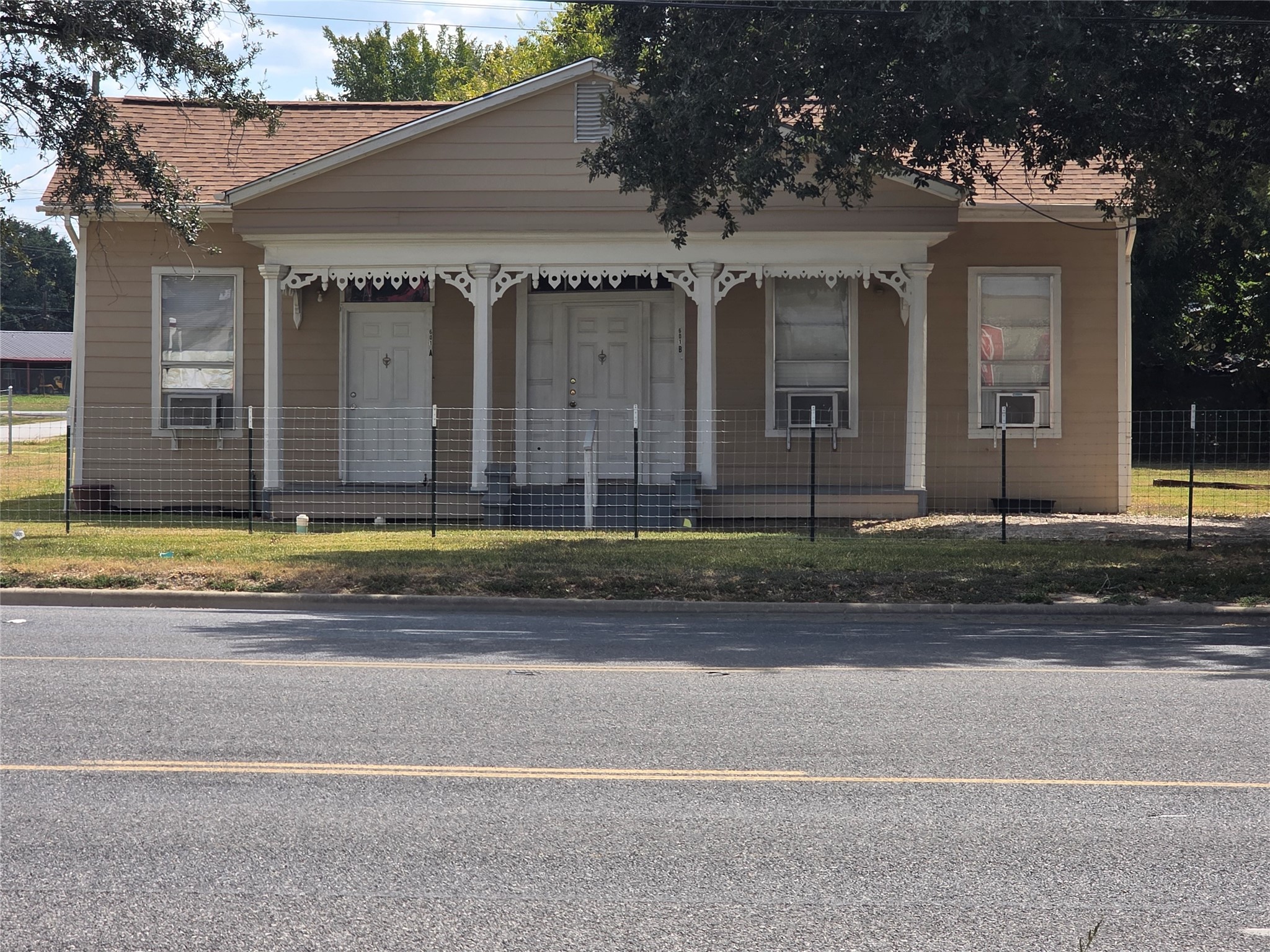 a view of a brick house with a yard