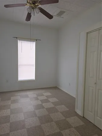 a view of an empty room and a window