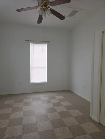 a view of an empty room and a window