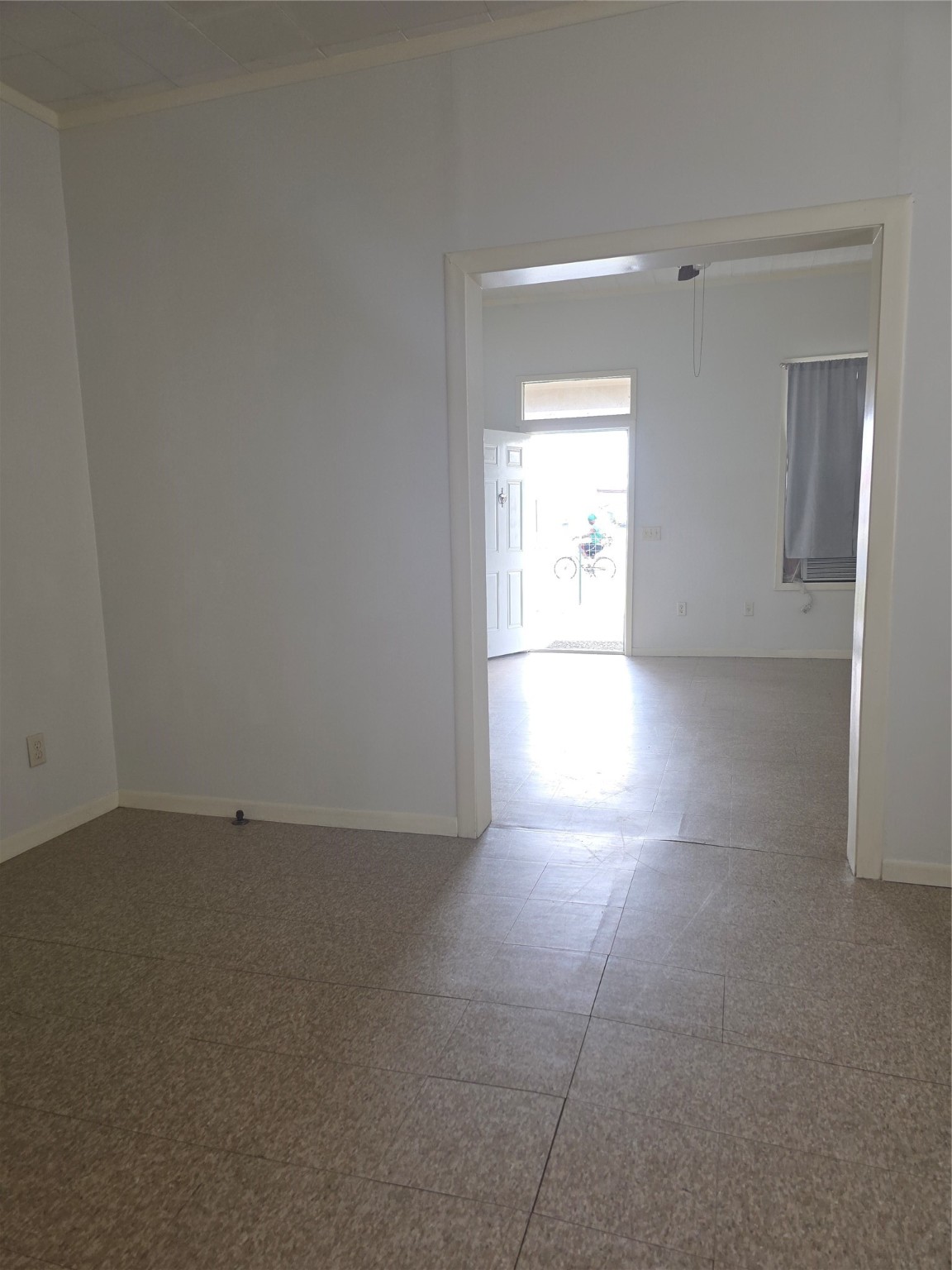 601 East Washington Avenue, Unit A Navasota, TX 77868 - Photo 7 of 17 an empty room with an empty space and a window
