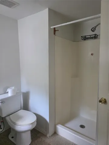 a white toilet sitting next to a bathroom