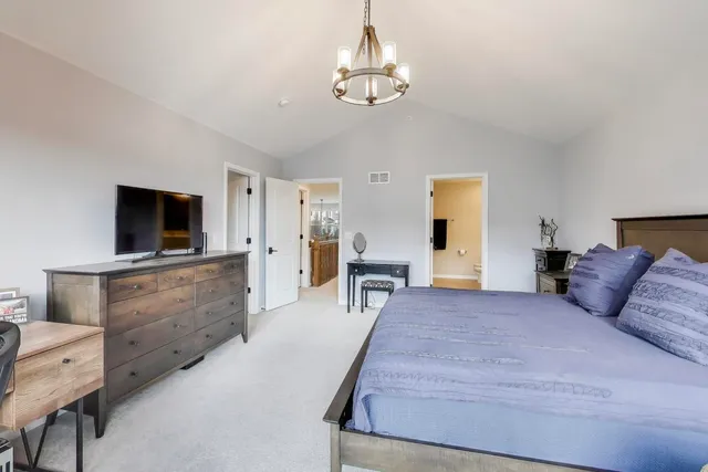 a bedroom with furniture and flat screen tv