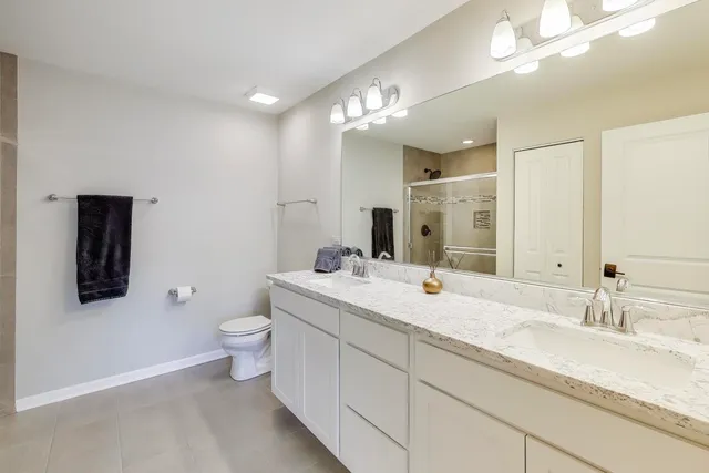 a bathroom with a sink a toilet and mirror