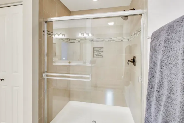 a bathroom with a glass shower door