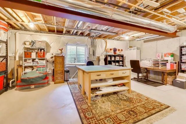 a bedroom with furniture and a rug
