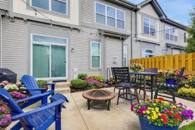 a view of patio with a table and chairs and potted plants