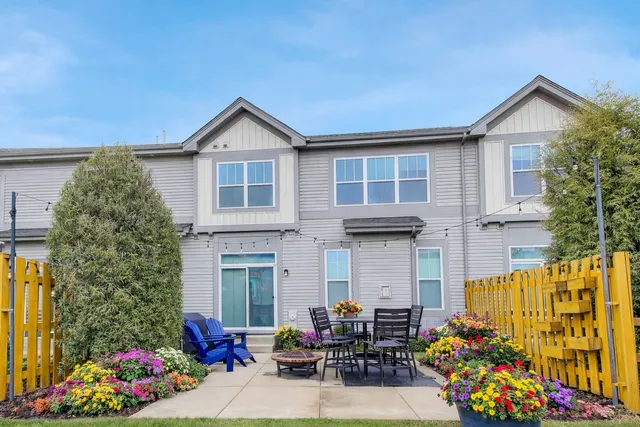 a view of a house with potted plants