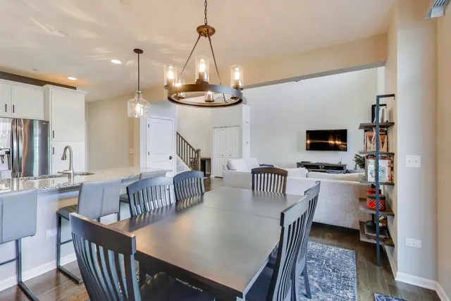 a view of a dining room with furniture and a chandelier