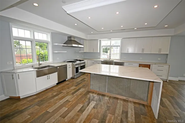 a kitchen with a sink wooden floor and view living room
