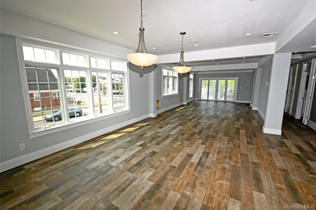 a view of a kitchen with wooden floor and window