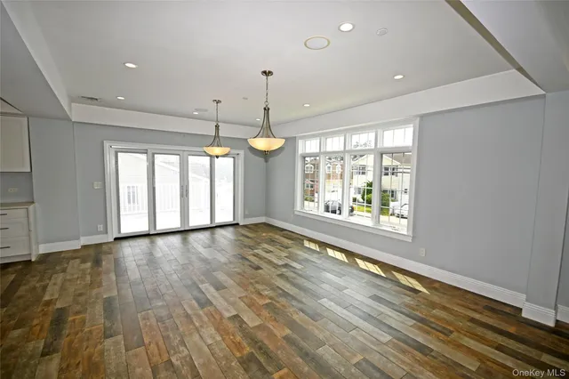 a view of an empty room with window and outdoor space