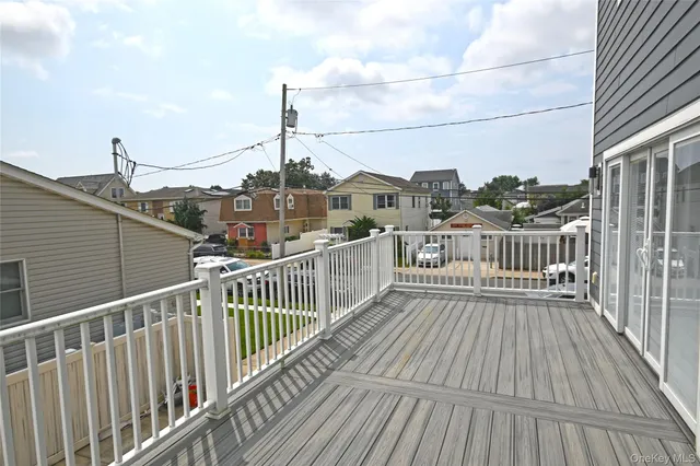 a view of an empty room with window wooden floor and a kitchen