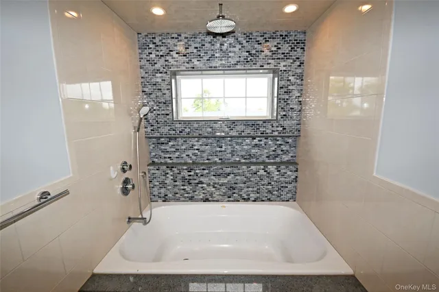a view of a balcony with wooden floor and iron fence