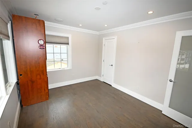an empty room with windows and closet