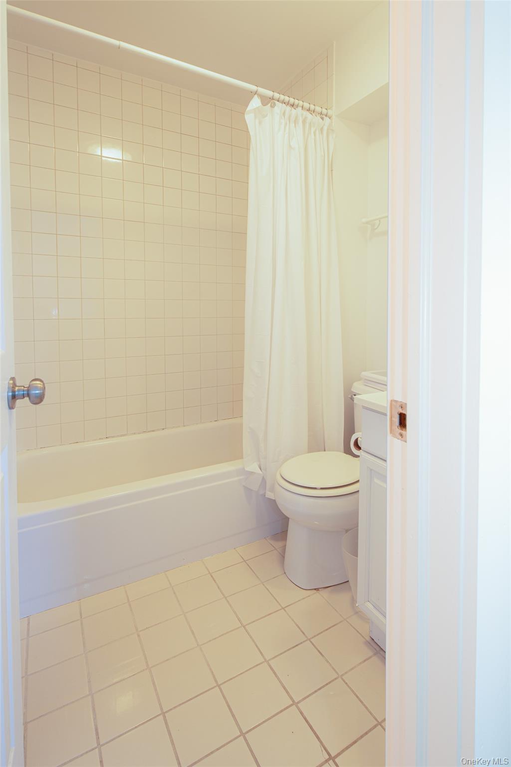 1 Canal Road Hampton Bays, NY 11946 - Photo 42 of 50 Full bathroom with light tile patterned flooring, shower / tub combo with curtain, and vanity