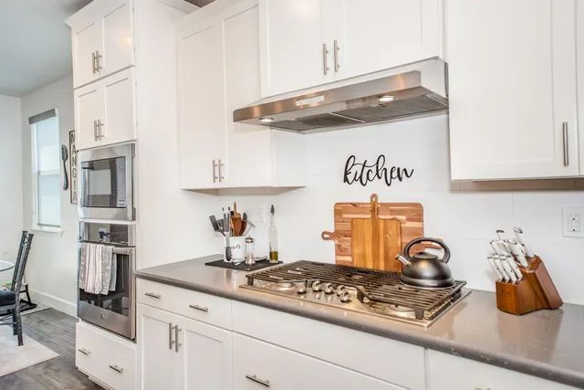 a kitchen with refrigerator a sink and wooden cabinets