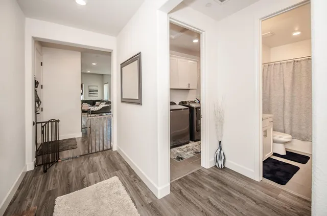 a very nice looking room with wooden floor and furniture