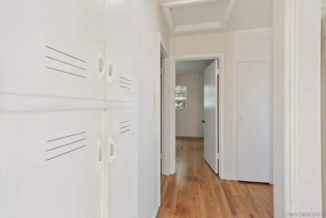 a view of a hallway with wooden floor