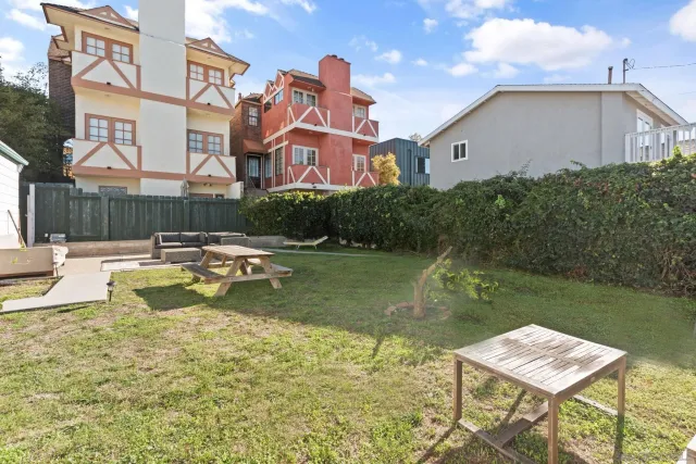 a view of a house with backyard and sitting area