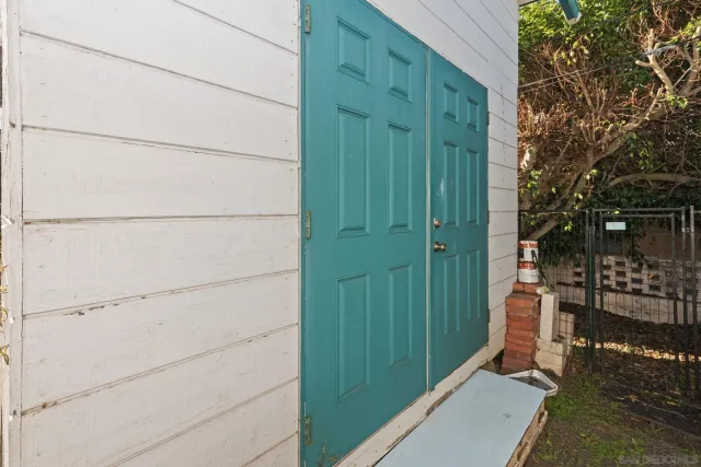 a backyard of a house with table and chairs