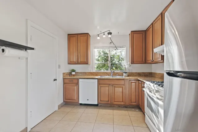 a kitchen with a sink stove and refrigerator