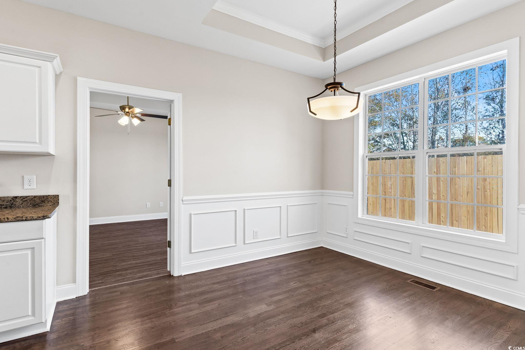 446 Sterling Drive Florence, SC 29501 - Photo 17 of 40 Unfurnished dining area with a tray ceiling, crown