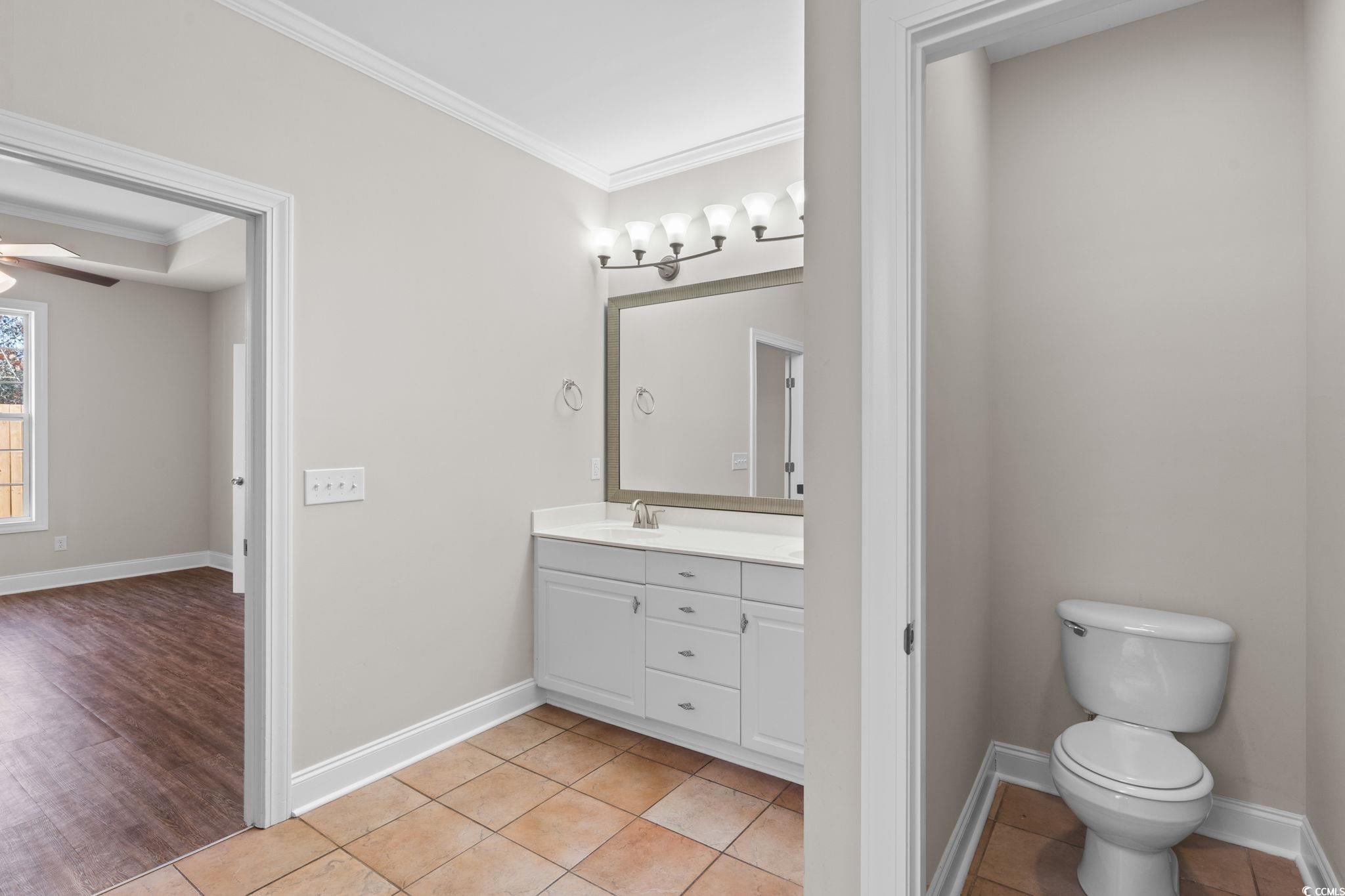 446 Sterling Drive Florence, SC 29501 - Photo 22 of 40 Bathroom featuring vanity, ceiling fan, crown mold