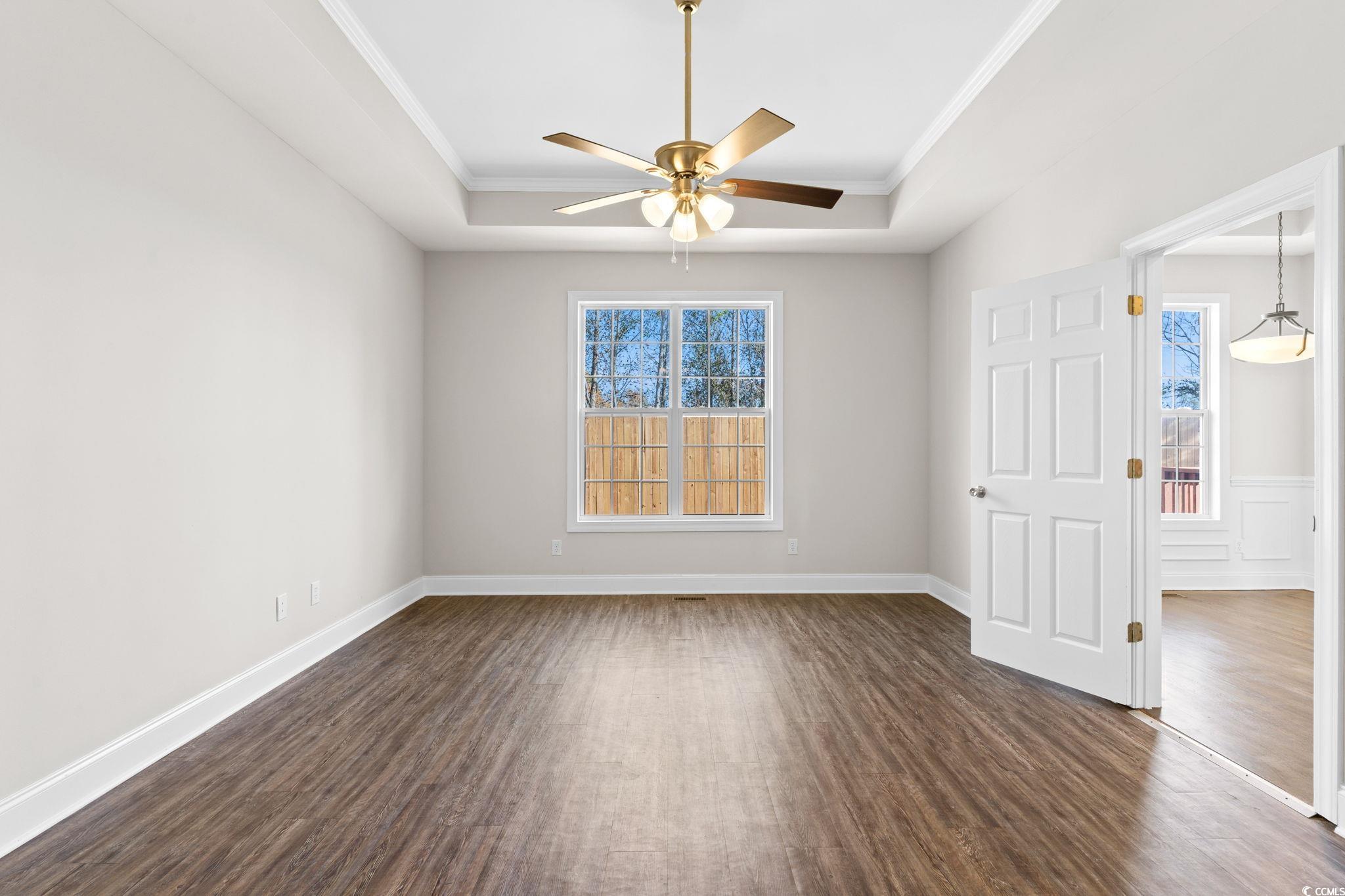 446 Sterling Drive Florence, SC 29501 - Photo 27 of 40 Spare room with a raised ceiling, dark wood-type f
