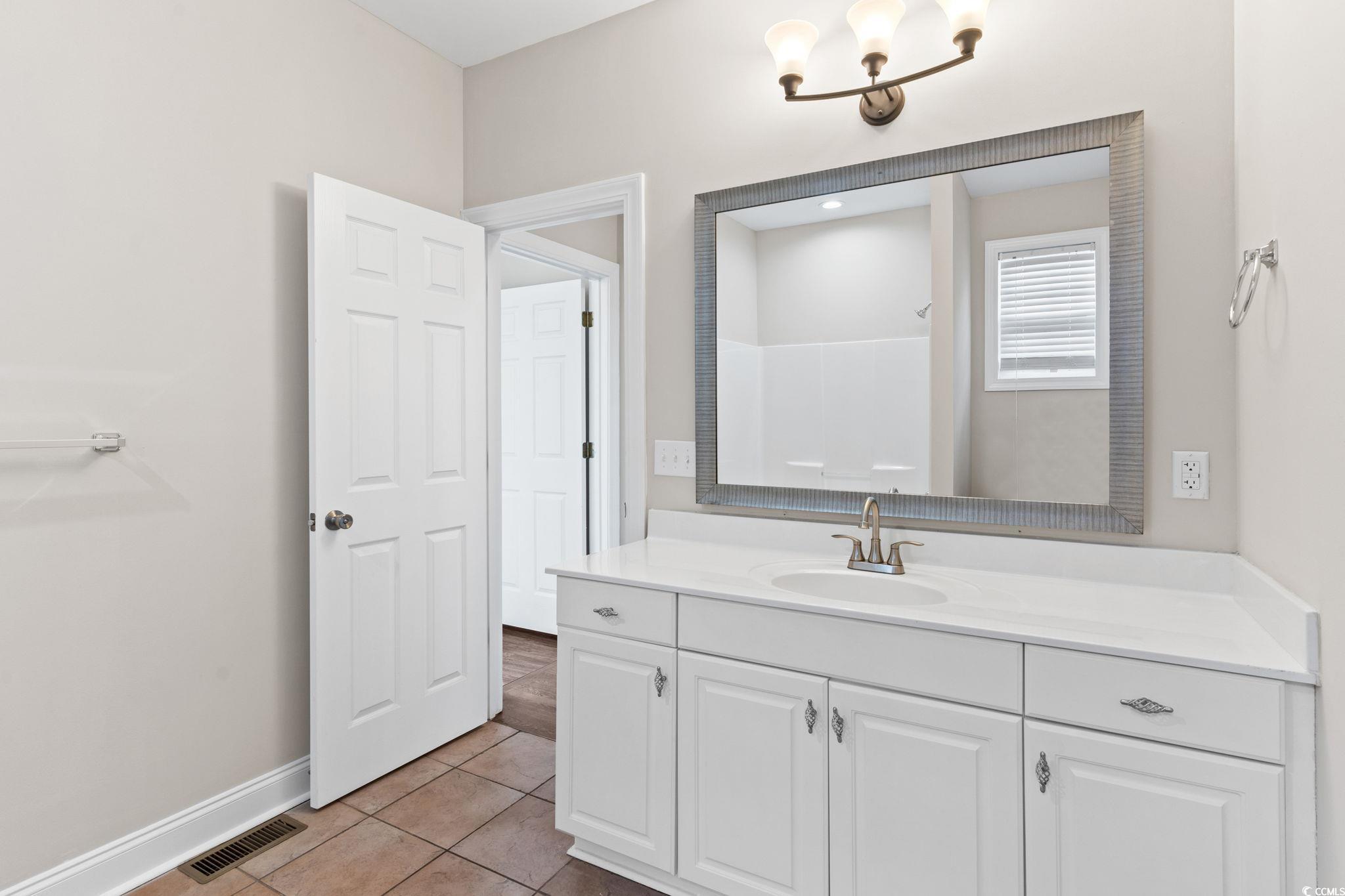 446 Sterling Drive Florence, SC 29501 - Photo 28 of 40 Bathroom with tile patterned floors, vanity, and a