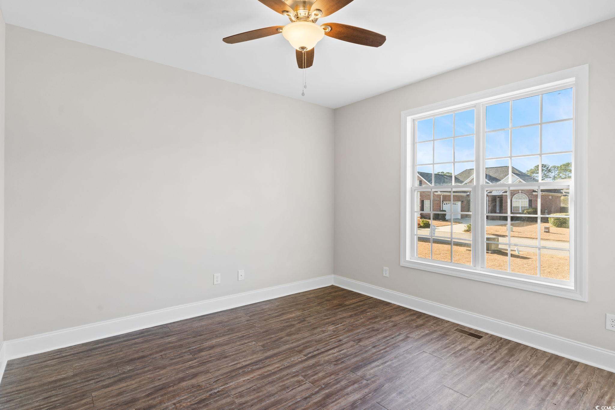 446 Sterling Drive Florence, SC 29501 - Photo 30 of 40 Empty room with ceiling fan and dark wood-type flo