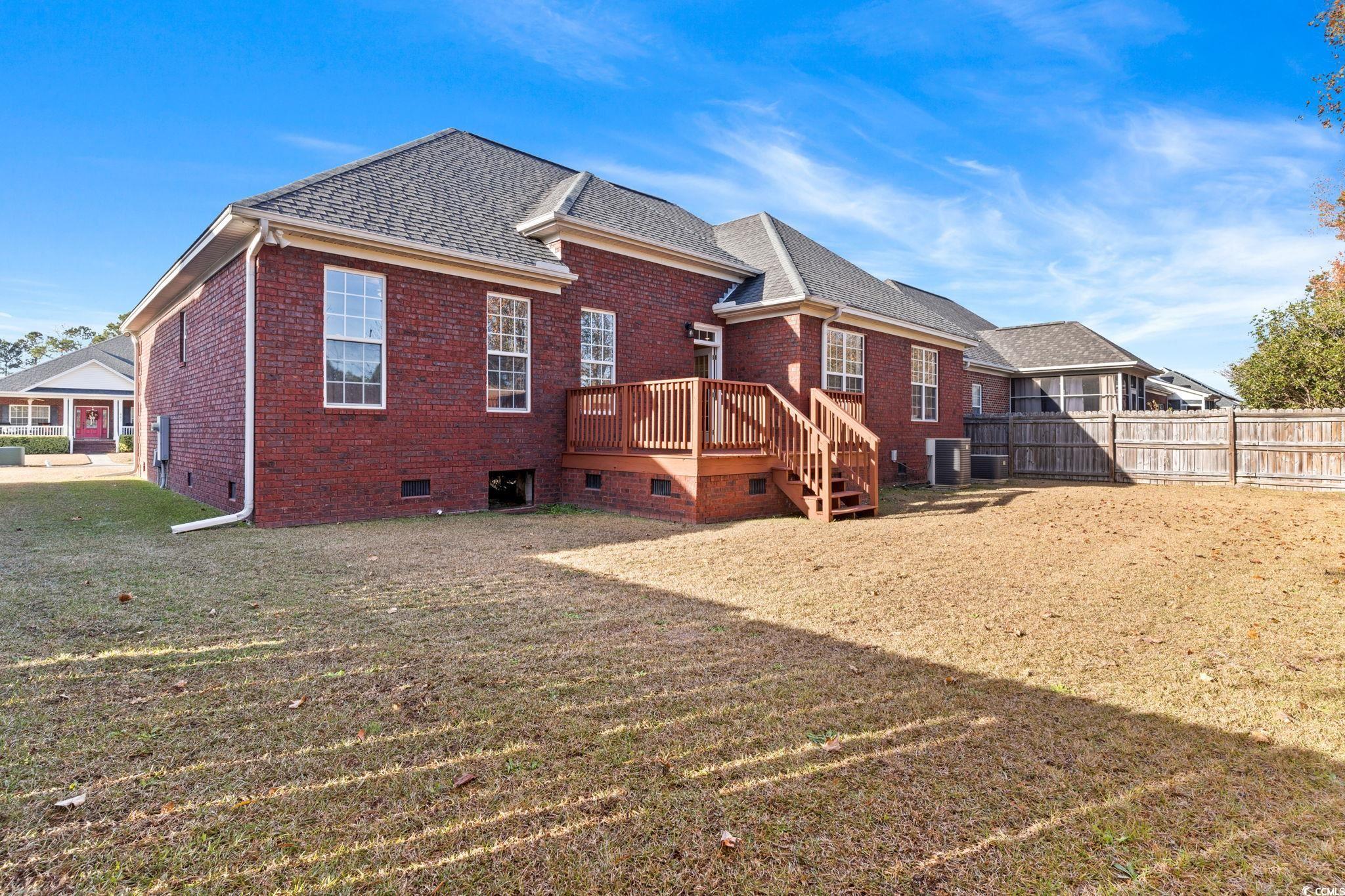 446 Sterling Drive Florence, SC 29501 - Photo 36 of 40 Rear view of house with a lawn, a deck, and centra