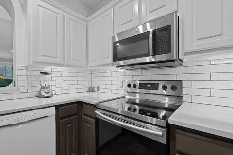 a kitchen with a sink stove and microwave