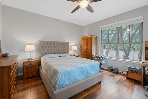 a bedroom with a bed and a large window