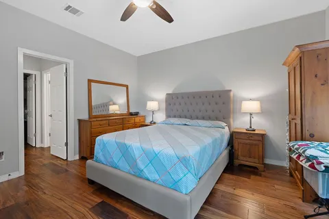 a bedroom with a bed and painting on the wall