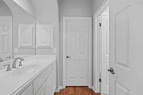 a bathroom with a sink and mirror