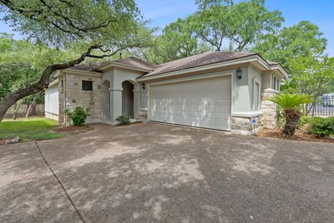 a view of a house with a yard and garage