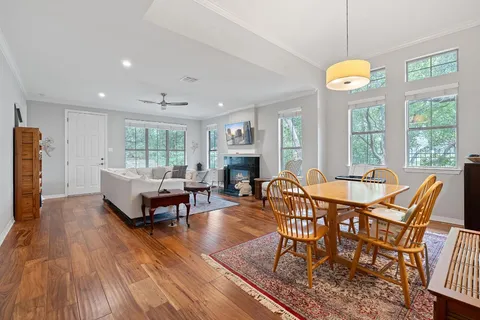a dining room with furniture a fireplace and wooden floor