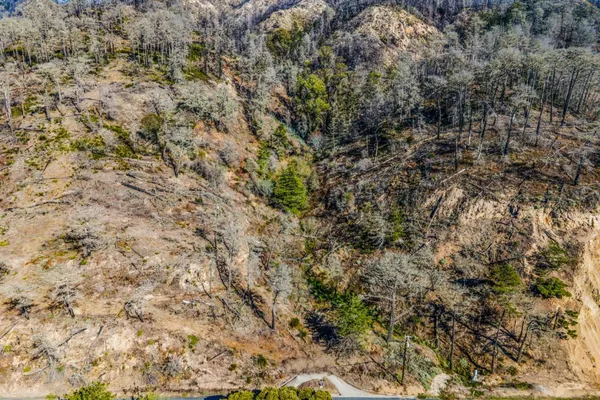 a view of a building with mountains in the background