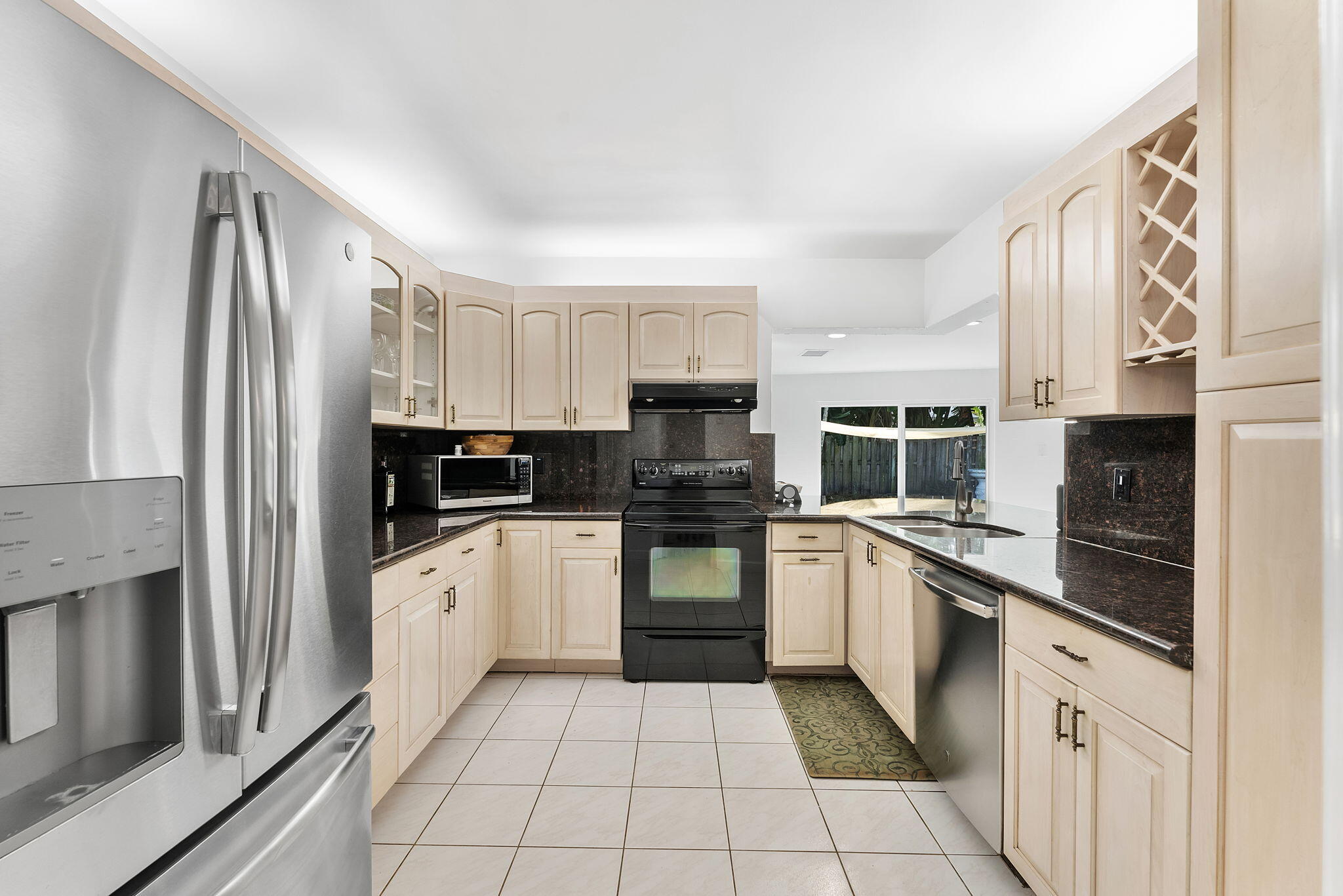 788 Northwest 7th Drive Boca Raton, FL 33486 - Photo 11 of 46 a kitchen with stainless steel appliances granite countertop a refrigerator and a stove top oven