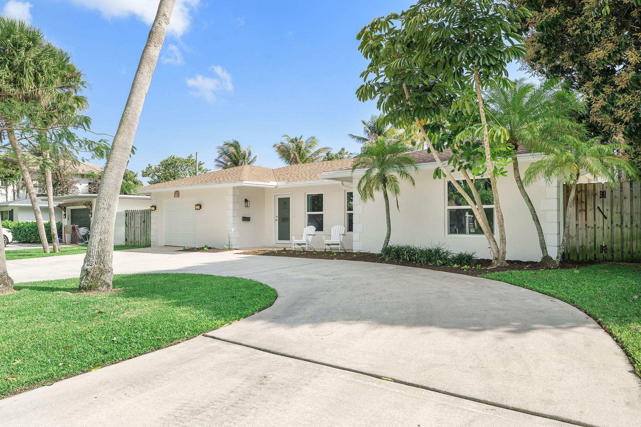 788 Northwest 7th Drive Boca Raton, FL 33486 - Photo 2 of 46 a view of a white house with a yard and plants