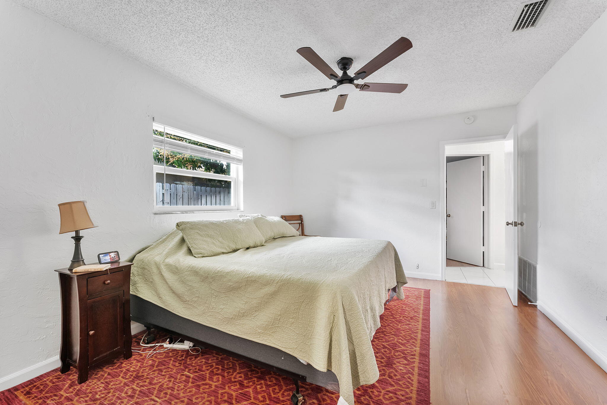 788 Northwest 7th Drive Boca Raton, FL 33486 - Photo 21 of 46 a bedroom with a bed and a chandelier