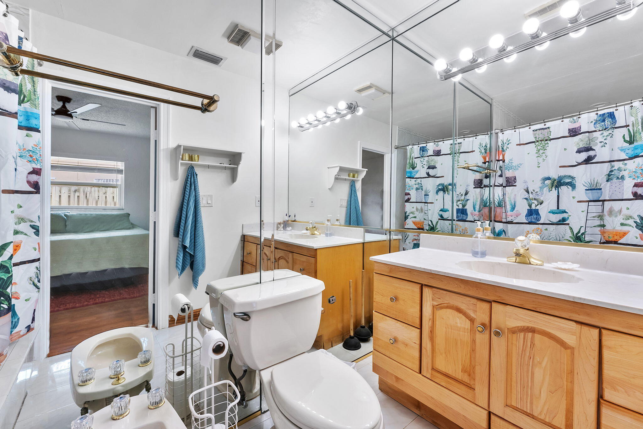 788 Northwest 7th Drive Boca Raton, FL 33486 - Photo 23 of 46 a bathroom with a sink vanity mirror and toilet