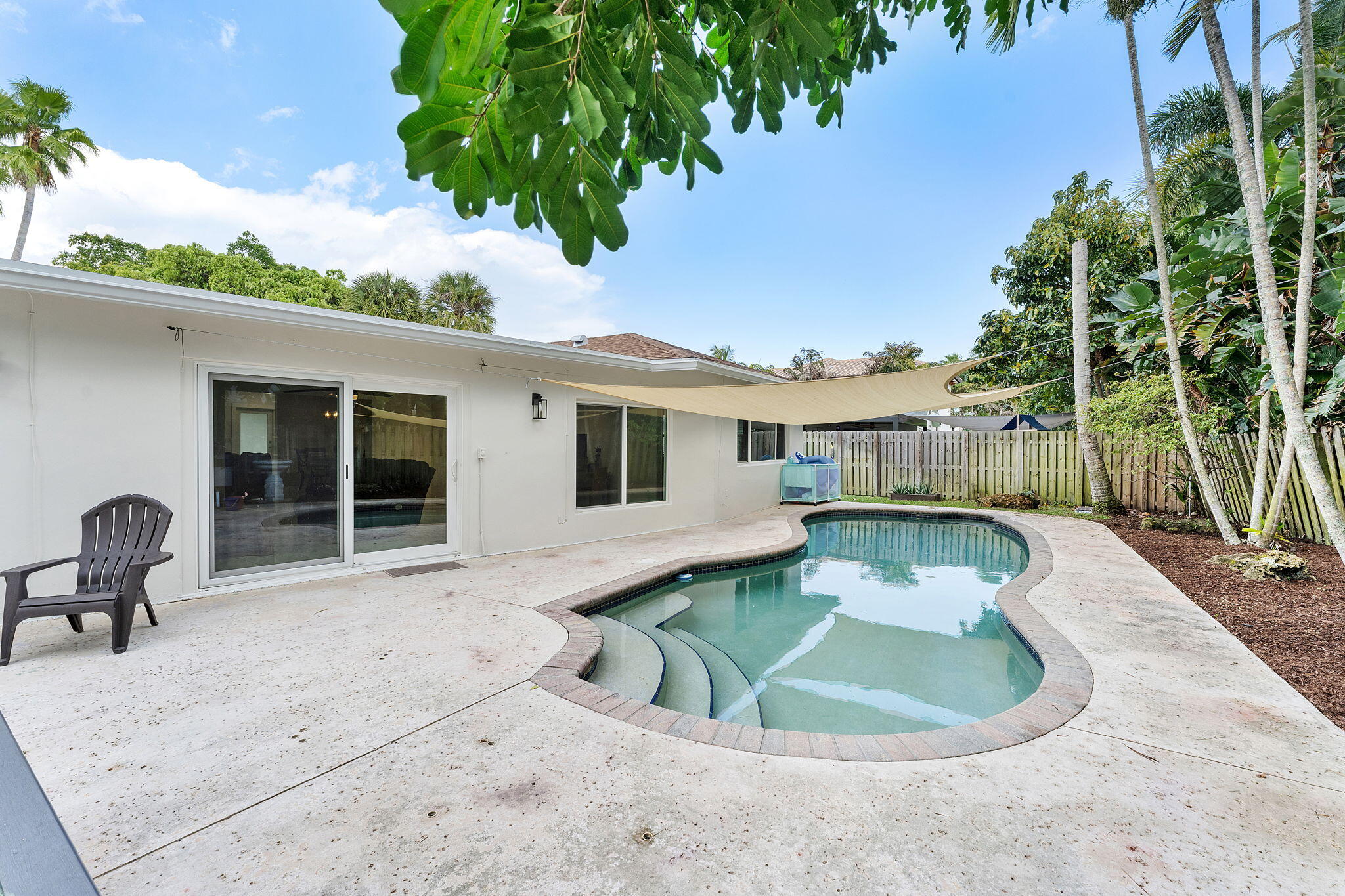 788 Northwest 7th Drive Boca Raton, FL 33486 - Photo 30 of 46 a view of a house with backyard sitting area and swimming pool