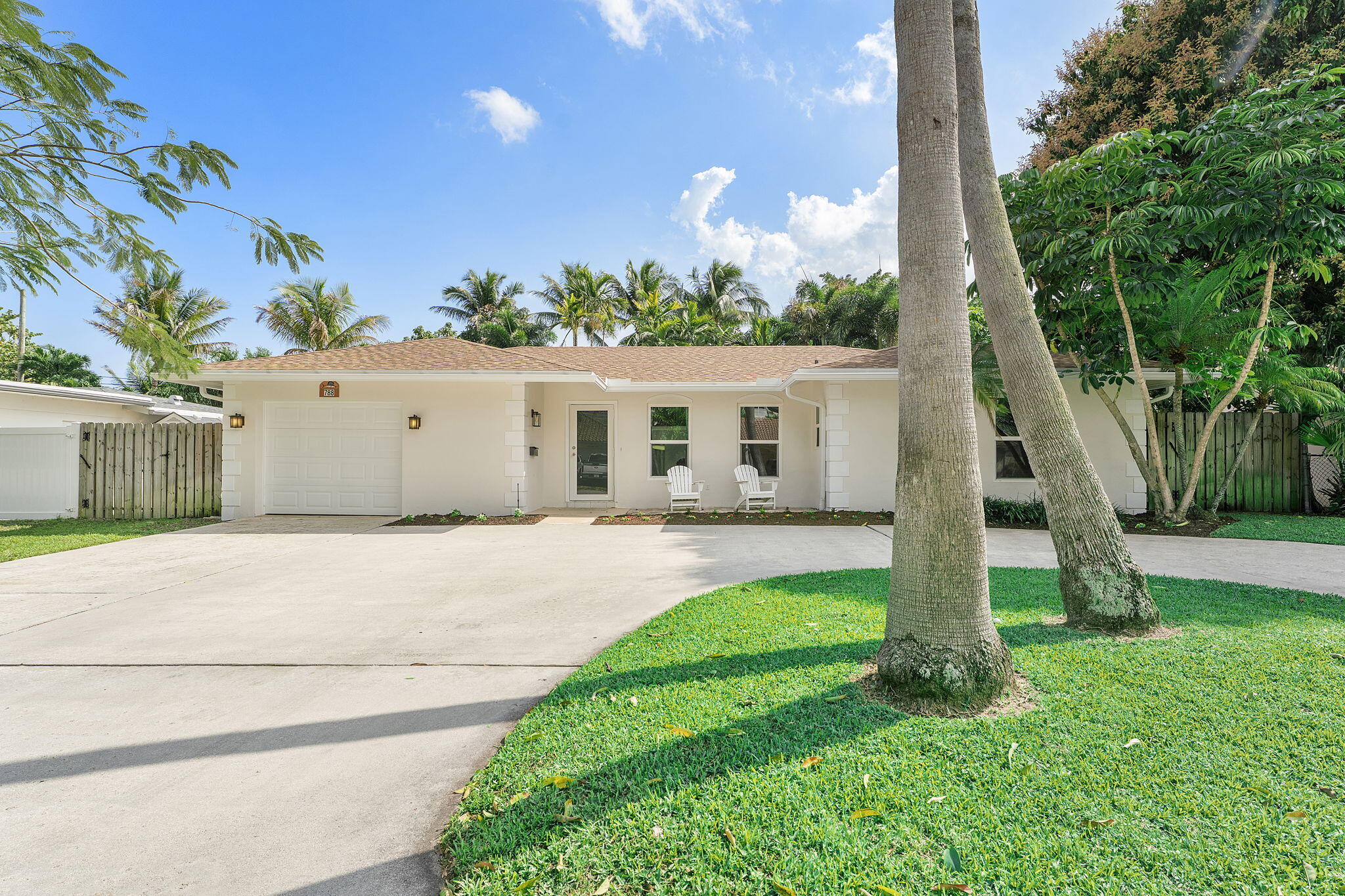 788 Northwest 7th Drive Boca Raton, FL 33486 - Photo 3 of 46 a front view of a house with a yard and a garage