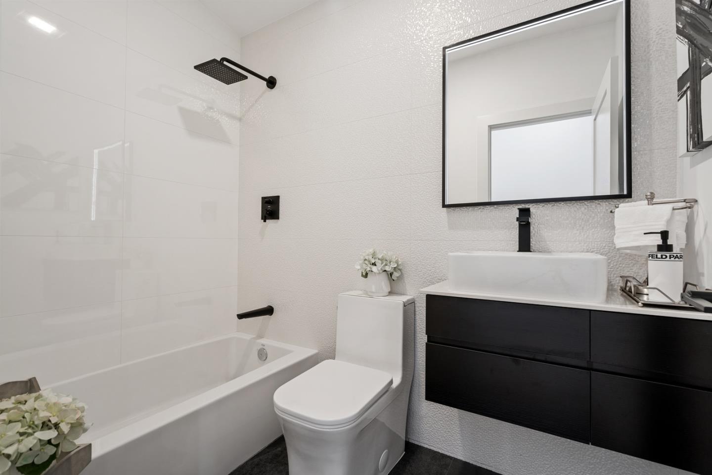 3633 Louis Road Palo Alto, CA 94303 - Photo 18 of 42 a bathroom with a toilet a sink a mirror a bathtub and vanity