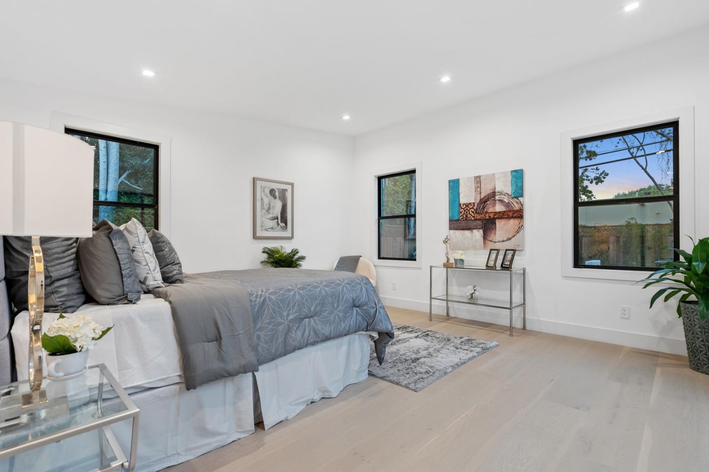 3633 Louis Road Palo Alto, CA 94303 - Photo 27 of 42 a bedroom with a large bed and a flat screen tv