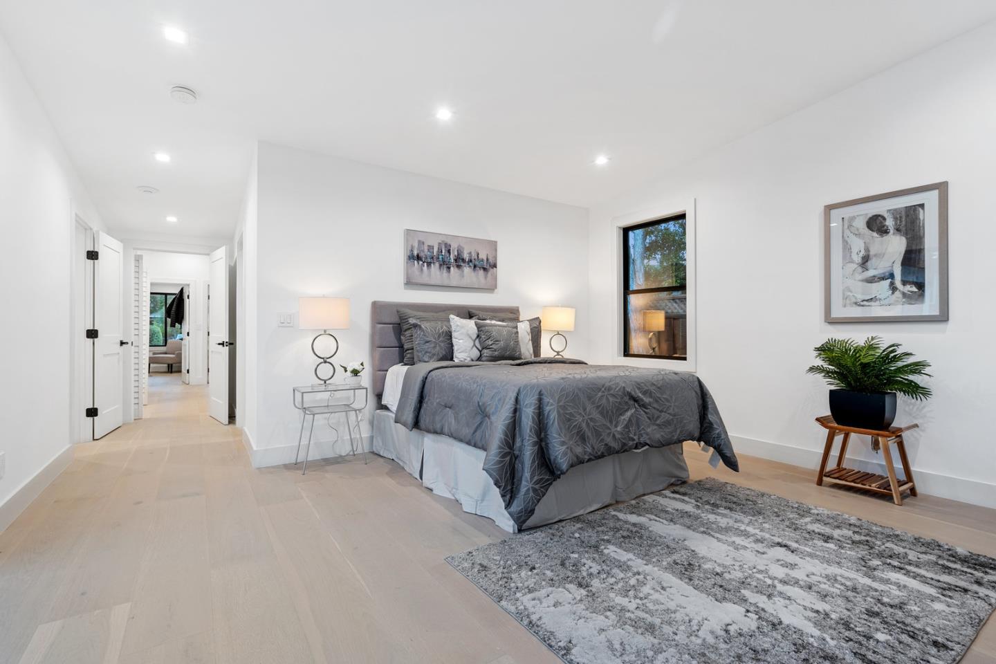 3633 Louis Road Palo Alto, CA 94303 - Photo 28 of 42 a bedroom with a large bed and a painting on the wall