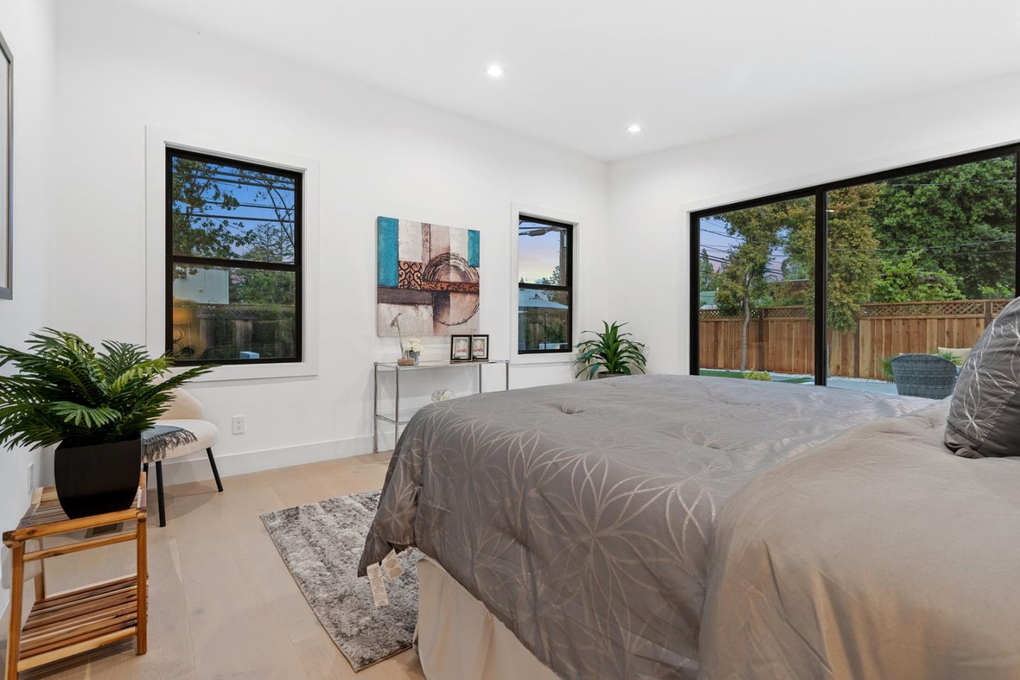 3633 Louis Road Palo Alto, CA 94303 - Photo 30 of 42 a bed sitting in a spacious bedroom next to a large window