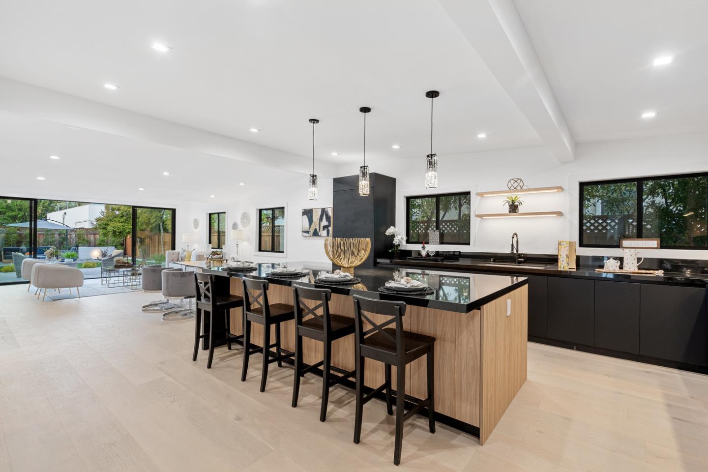 3633 Louis Road Palo Alto, CA 94303 - Photo 3 of 42 a kitchen with stainless steel appliances kitchen island granite countertop a table and chairs